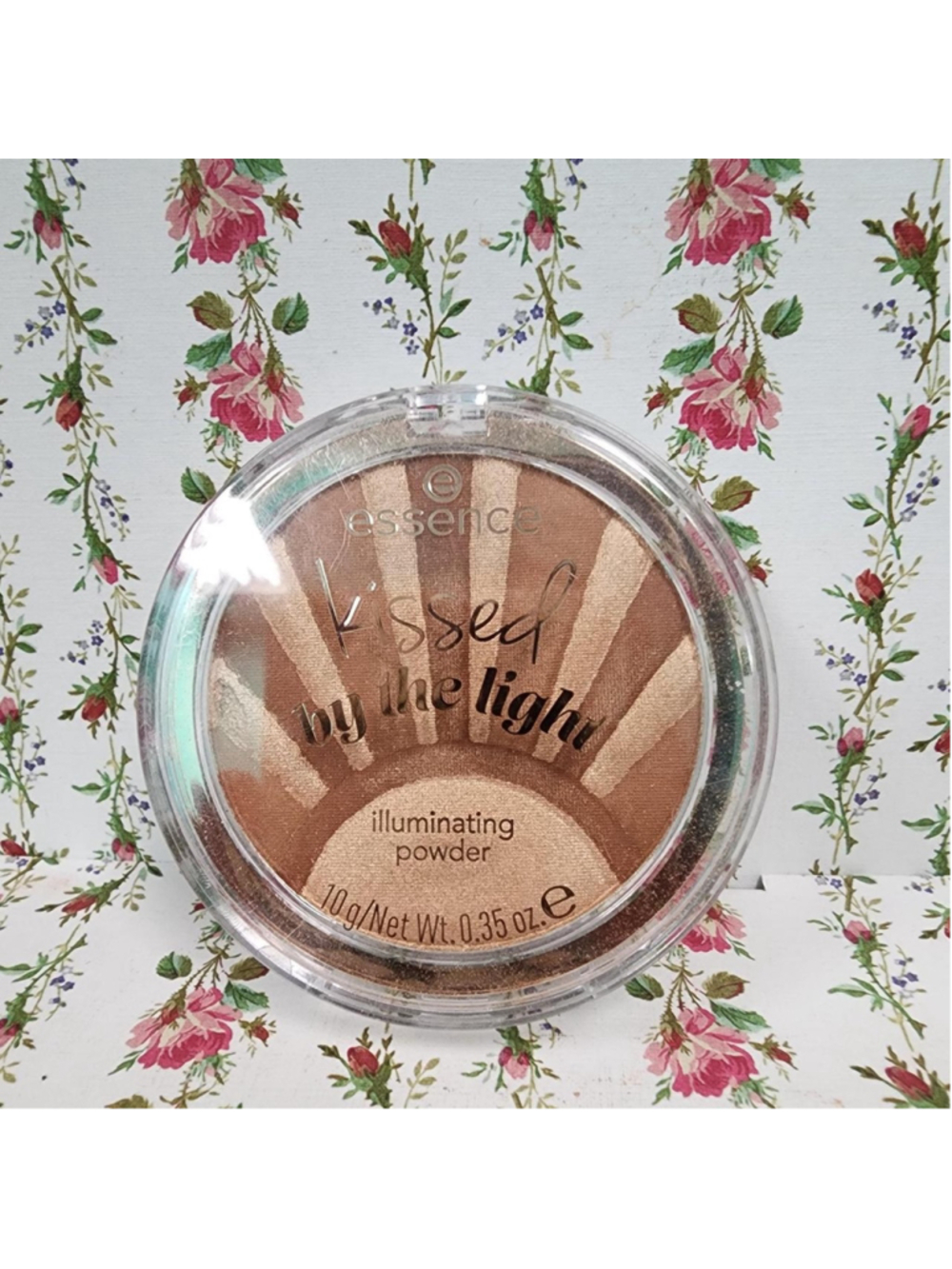 Essence Kissed by the Light Illuminating Powder in a sunburst design with shades